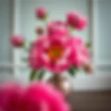 Vibrant peony faux flowers arrangement in a decorative vase