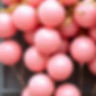 A close-up of blush pink balloons paired with golden decorations