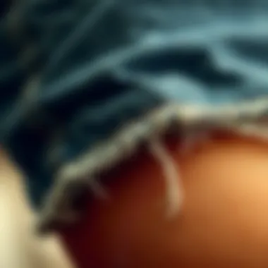 Close-up of the texture and details of ripped hem mom jeans