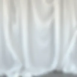 Elegant draping showcasing the fluidity of white fabric in a fashion setting