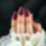 A striking dark red nail design with intricate patterns showcasing elegance.