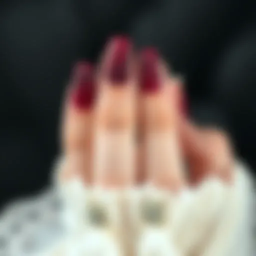 Intricate Patterns on Dark Red Nails A striking dark red nail design with intricate patterns showcasing elegance.