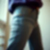 Detailed view of petite high-waisted bell bottom jeans showcasing fabric texture
