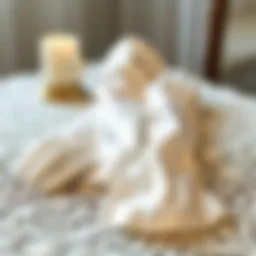 Elegant white satin elbow length gloves draped on a vintage lace tablecloth