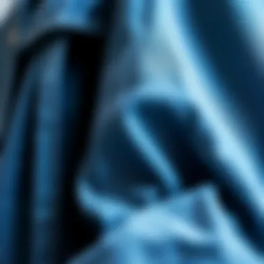 A close-up of the fabric texture of a three quarter length denim jacket